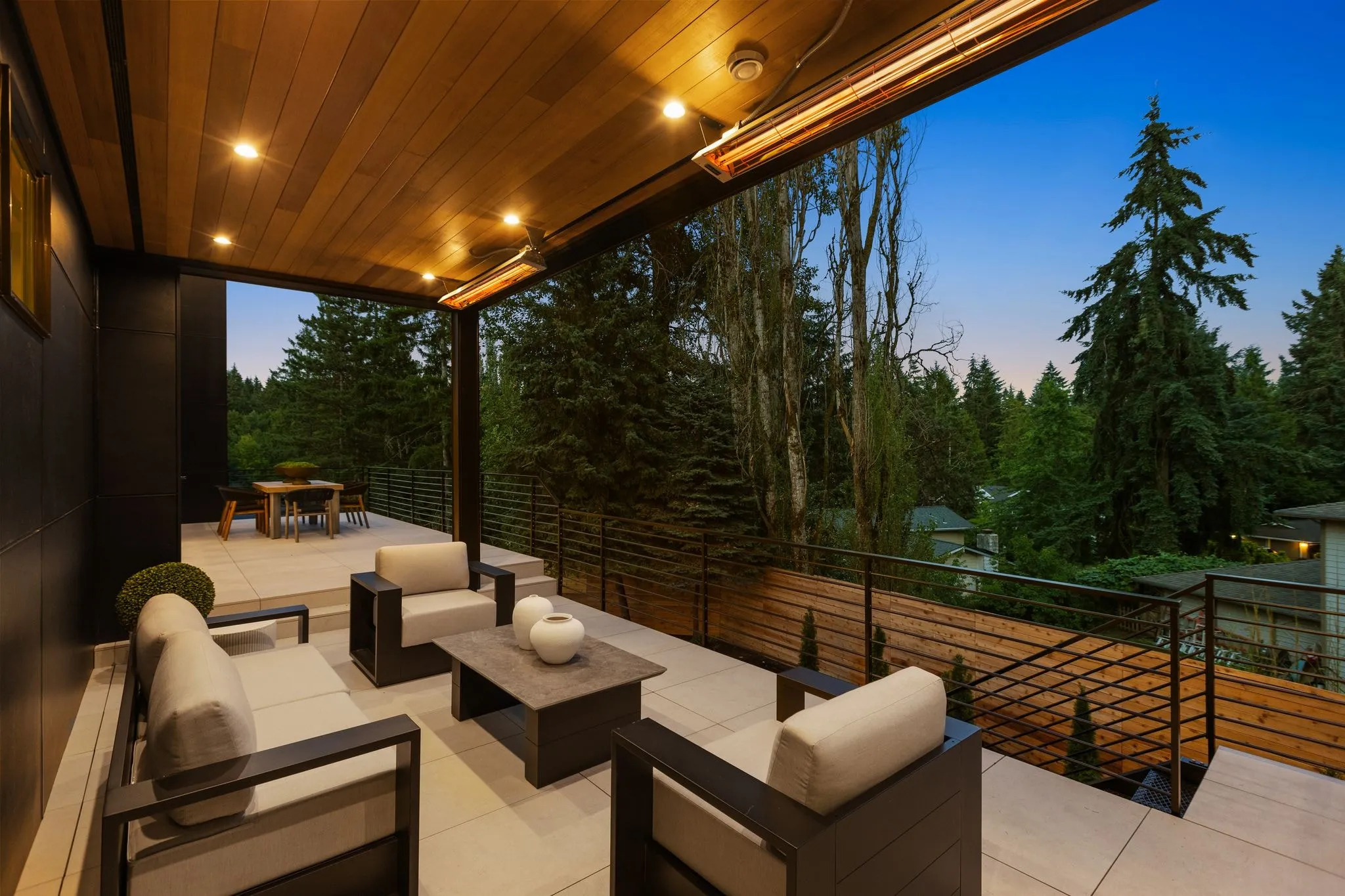 Lit covered deck photographed at dusk by ACRE Seattle